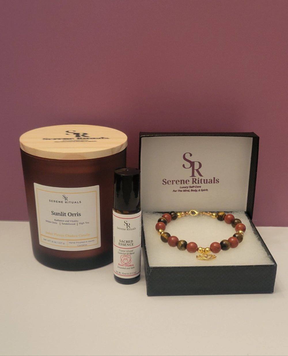 Serene Rituals product set including a candle, bottle, and bracelet on a white surface with a purple background.