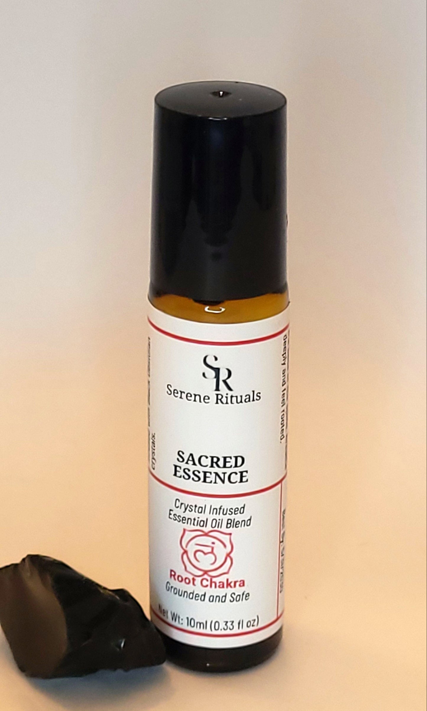 Sacred Essence essential oil bottle with a label on a light background