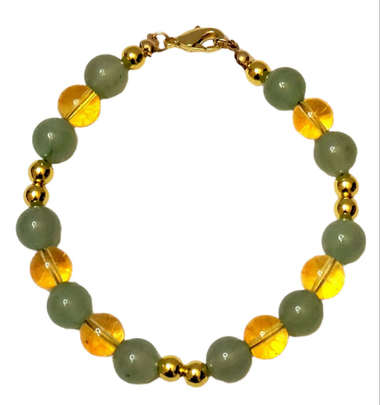 Abundant Glow Bracelet with Green Aventurine and Yellow Citrine gemstone beads and gold accents on a light background