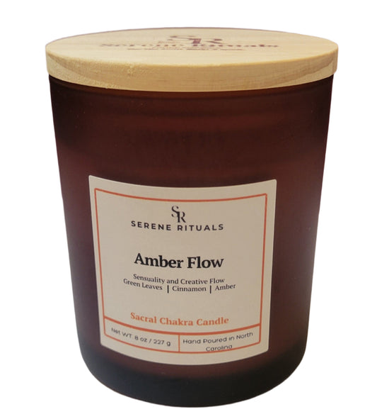 Serene Rituals Amber Flow candle with wooden lid on a white surface against a purple background