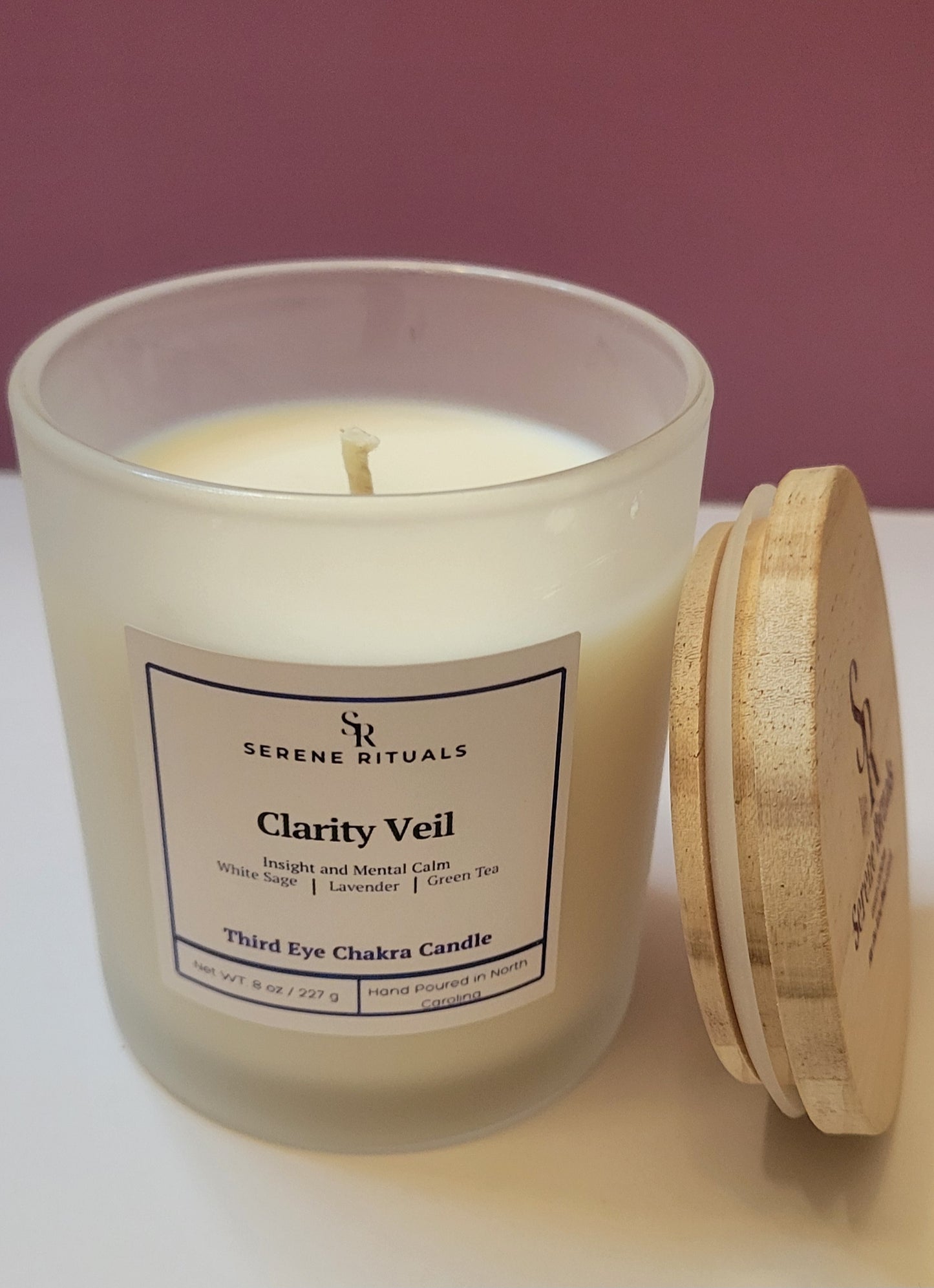 Serene Rituals Clarity Veil candle with wooden lid on a white surface