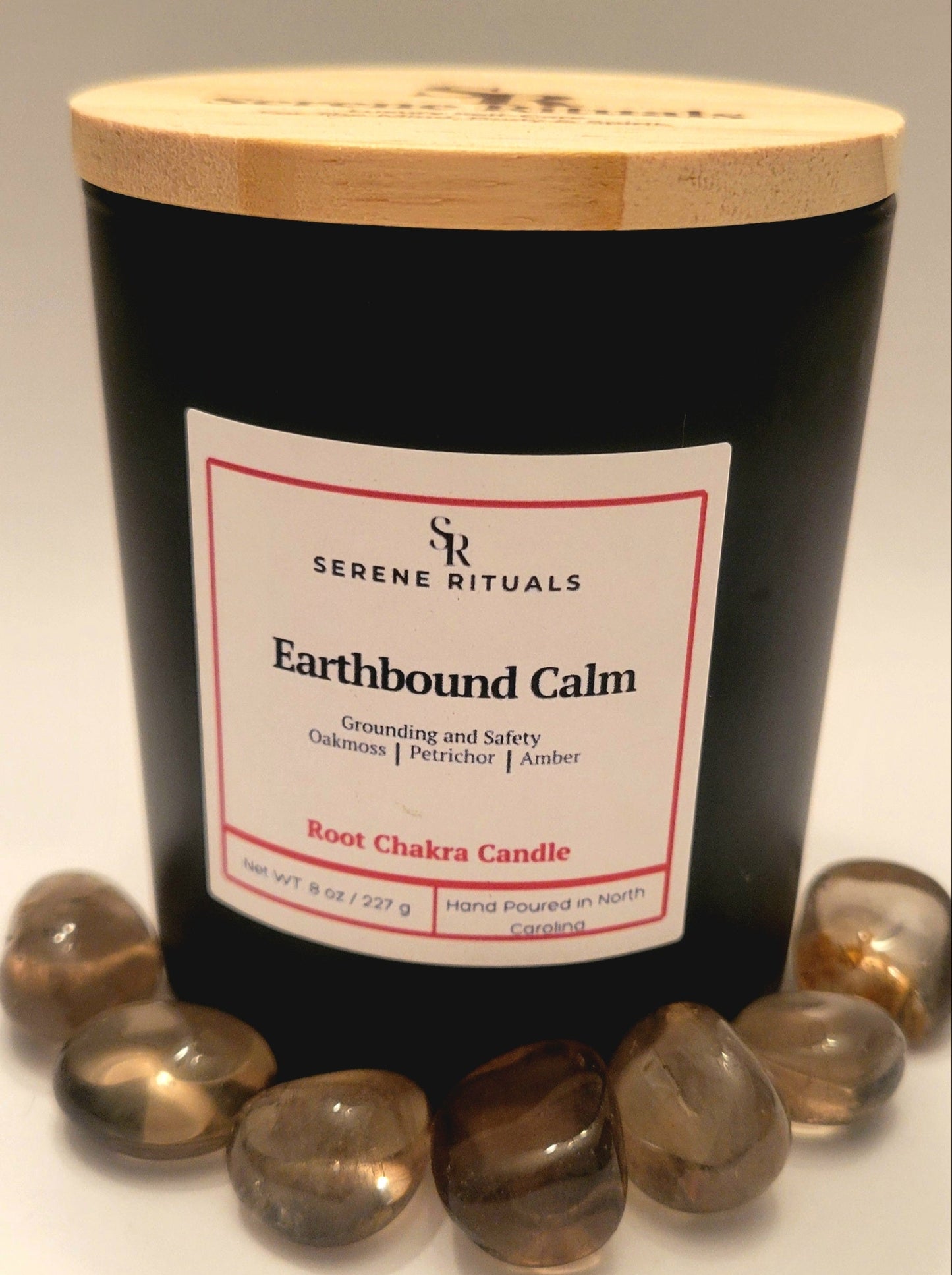 Earthbound Calm candle with wooden lid and 'Serene Rituals' label on a white background