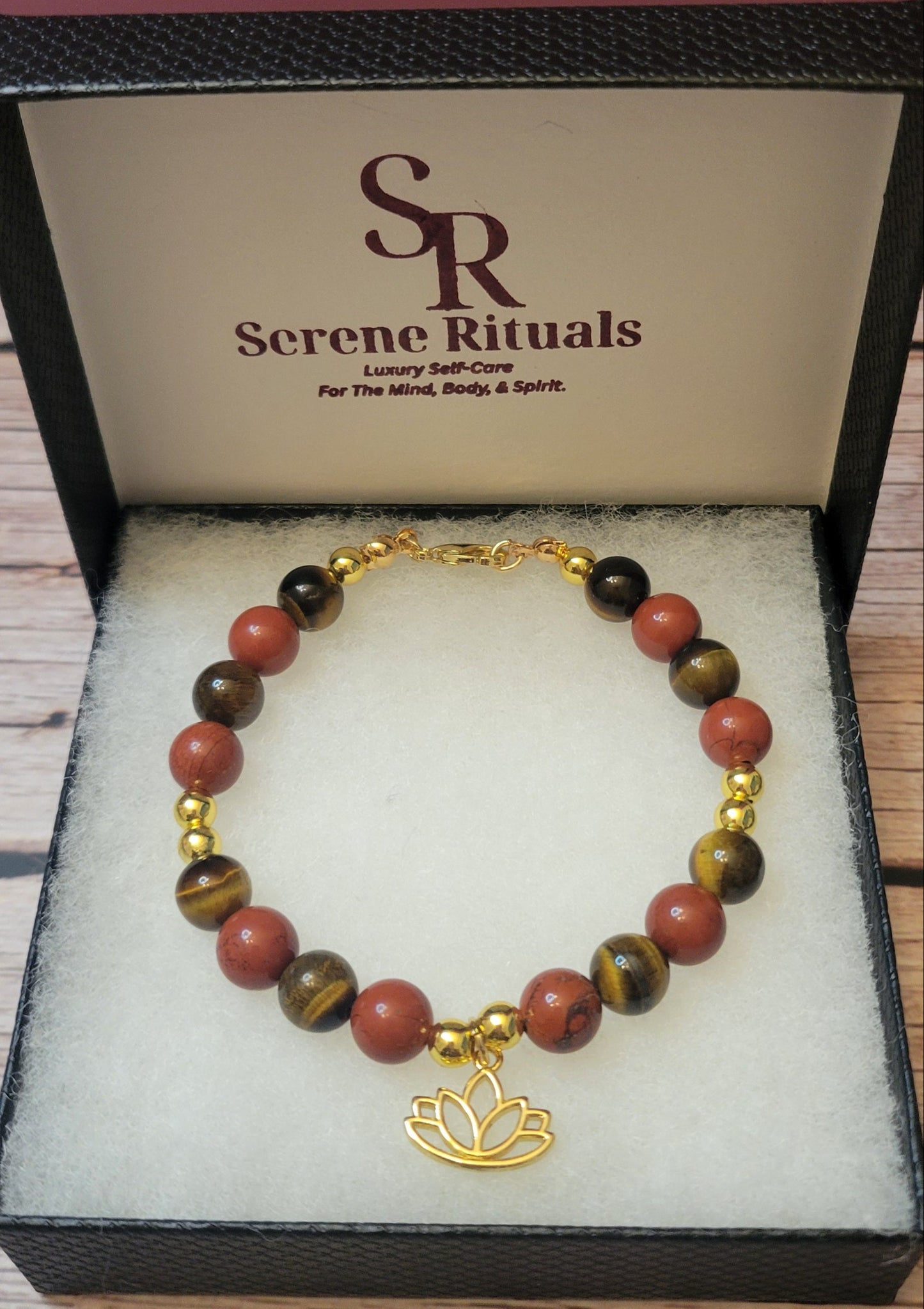 Fearless Strength Bracelet with Tiger's Eye and Red  Jasper  with gold lotus charm in a 'Serene Rituals' box.