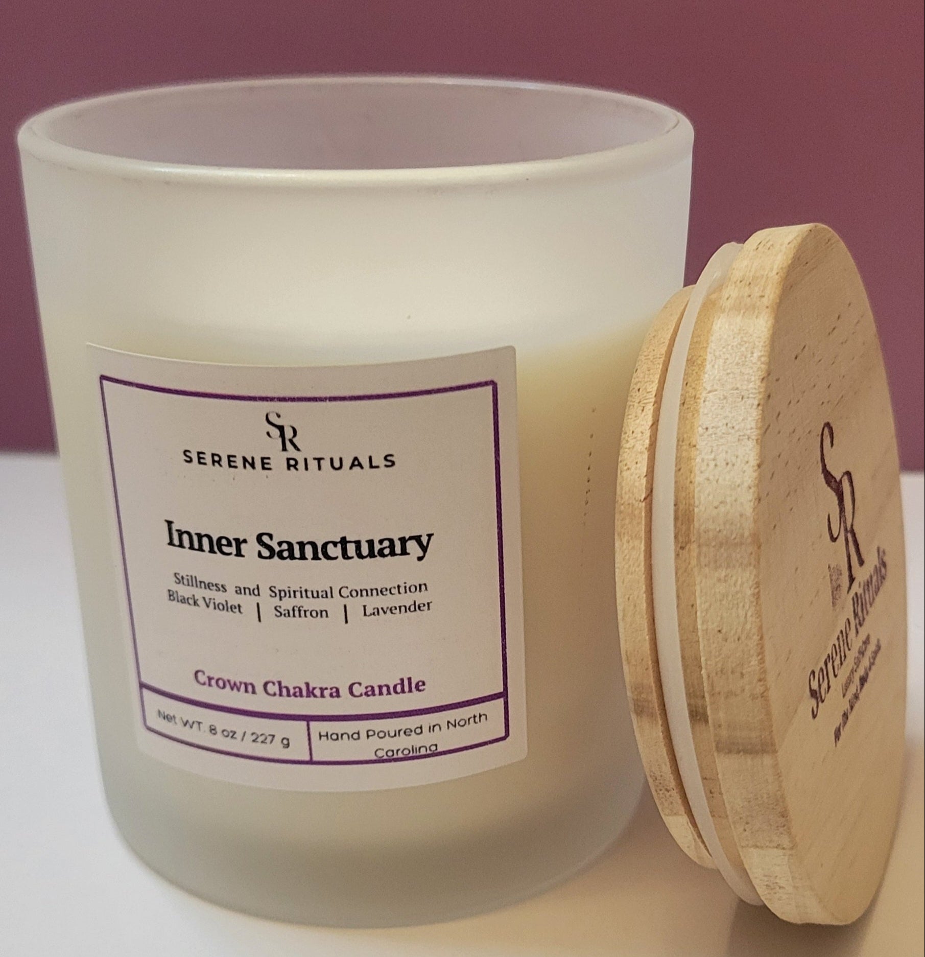 Inner Sanctuary candle with a wooden lid and 'Serene Rituals' label on a white surface.
