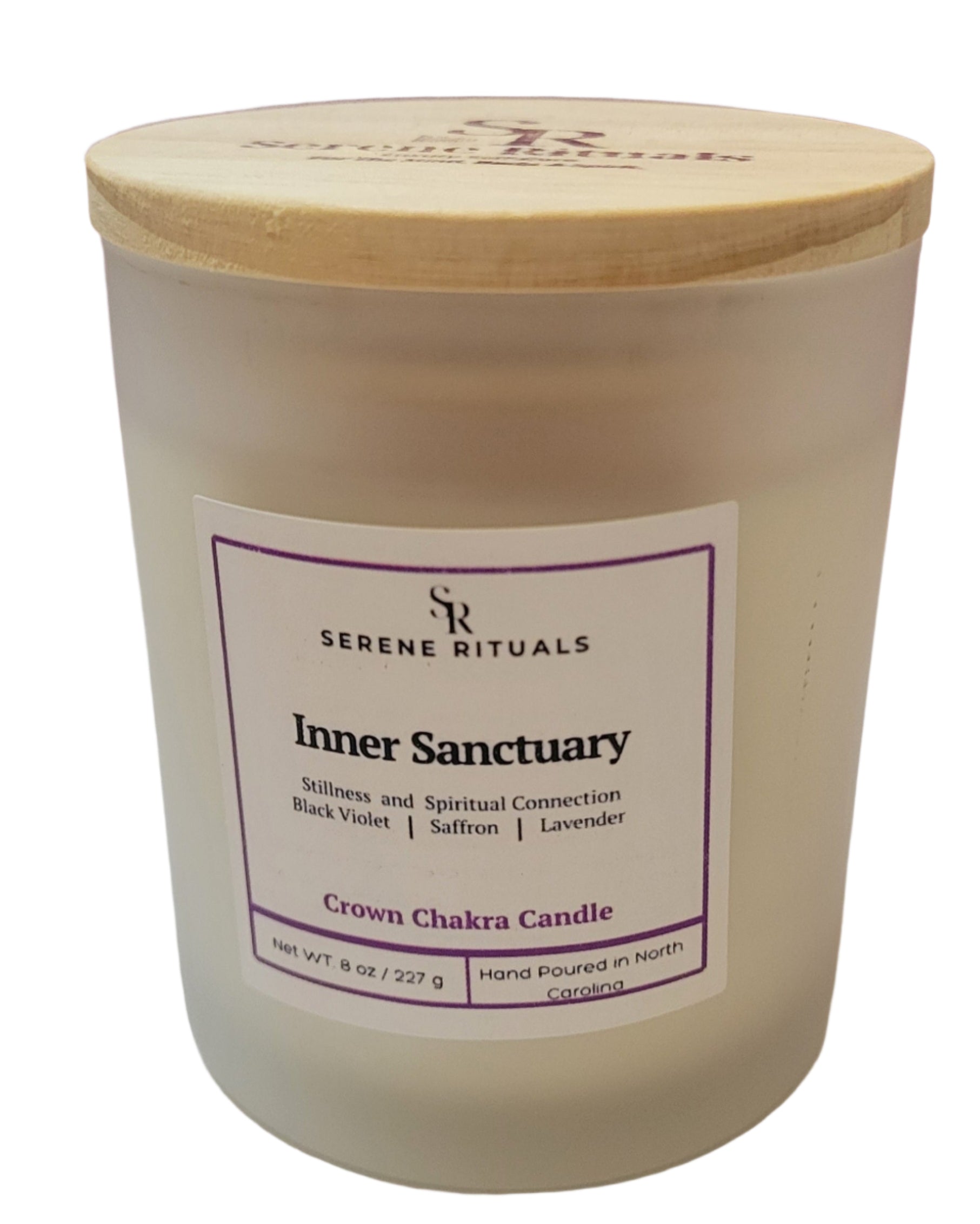Candle with a wooden lid labeled 'Inner Sanctuary' by Serene Rituals on a white surface.
