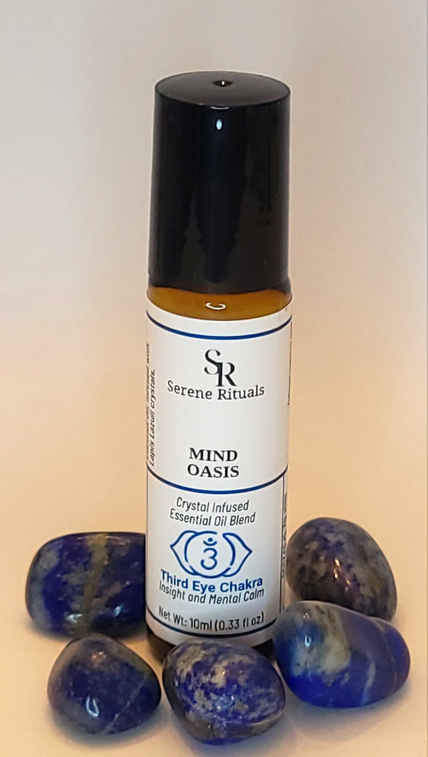 Roll-on bottle with label and blue Lapis Lazuli  on a light background