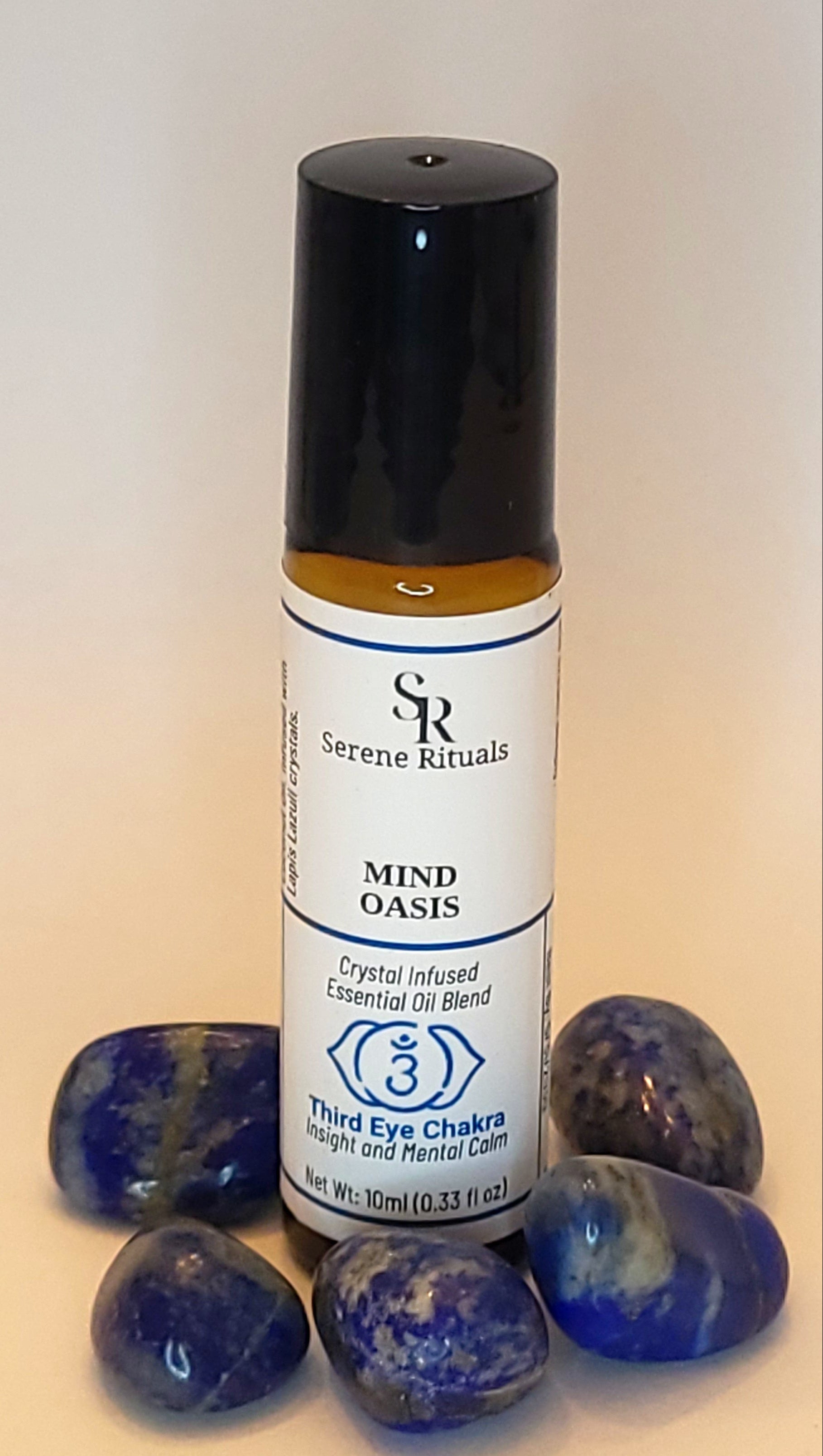 Roll-on bottle with label and blue Lapis Lazuli  on a light background