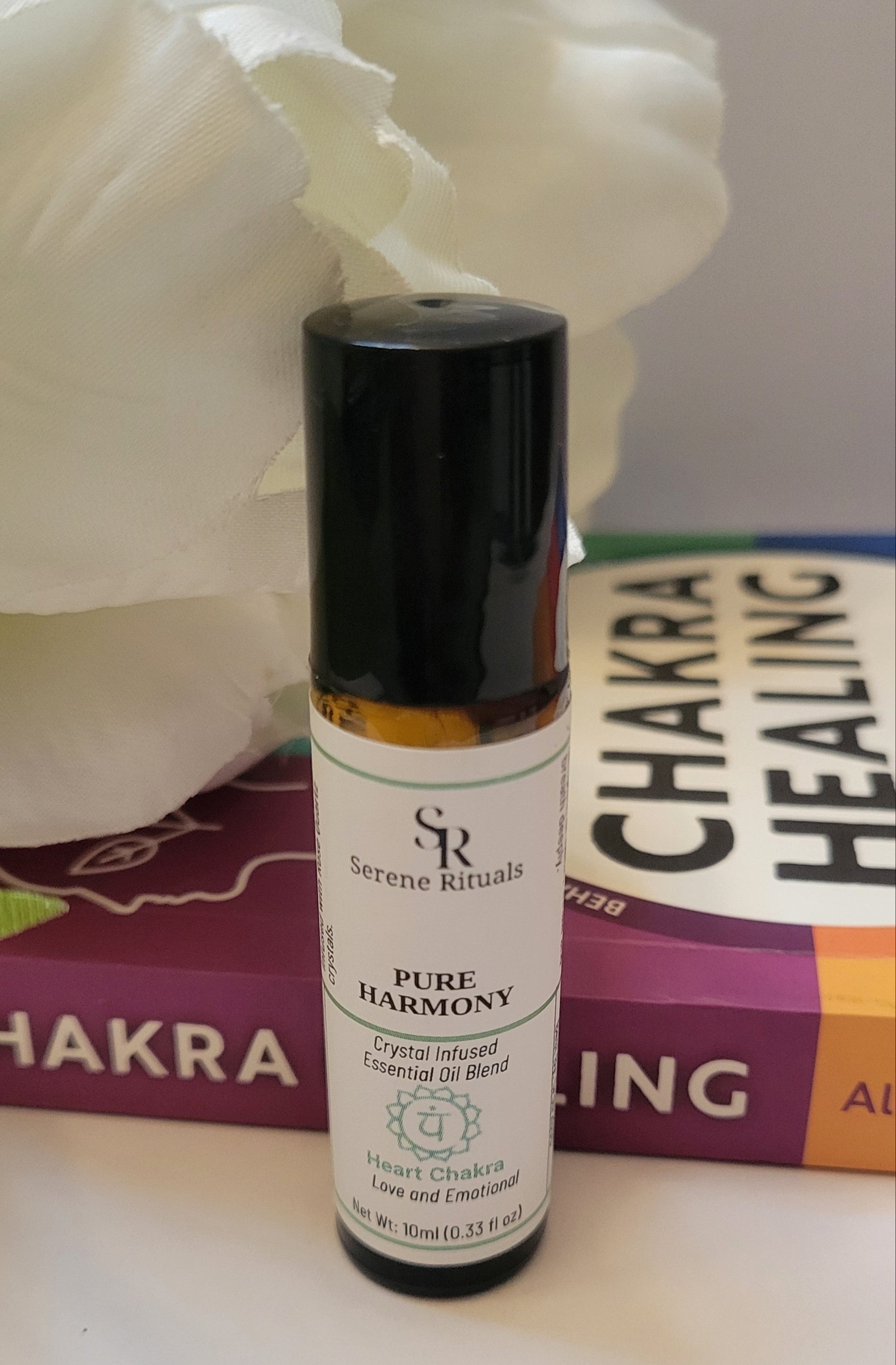 Serene Rituals Pure Harmony essential oil bottle with a book in the background
