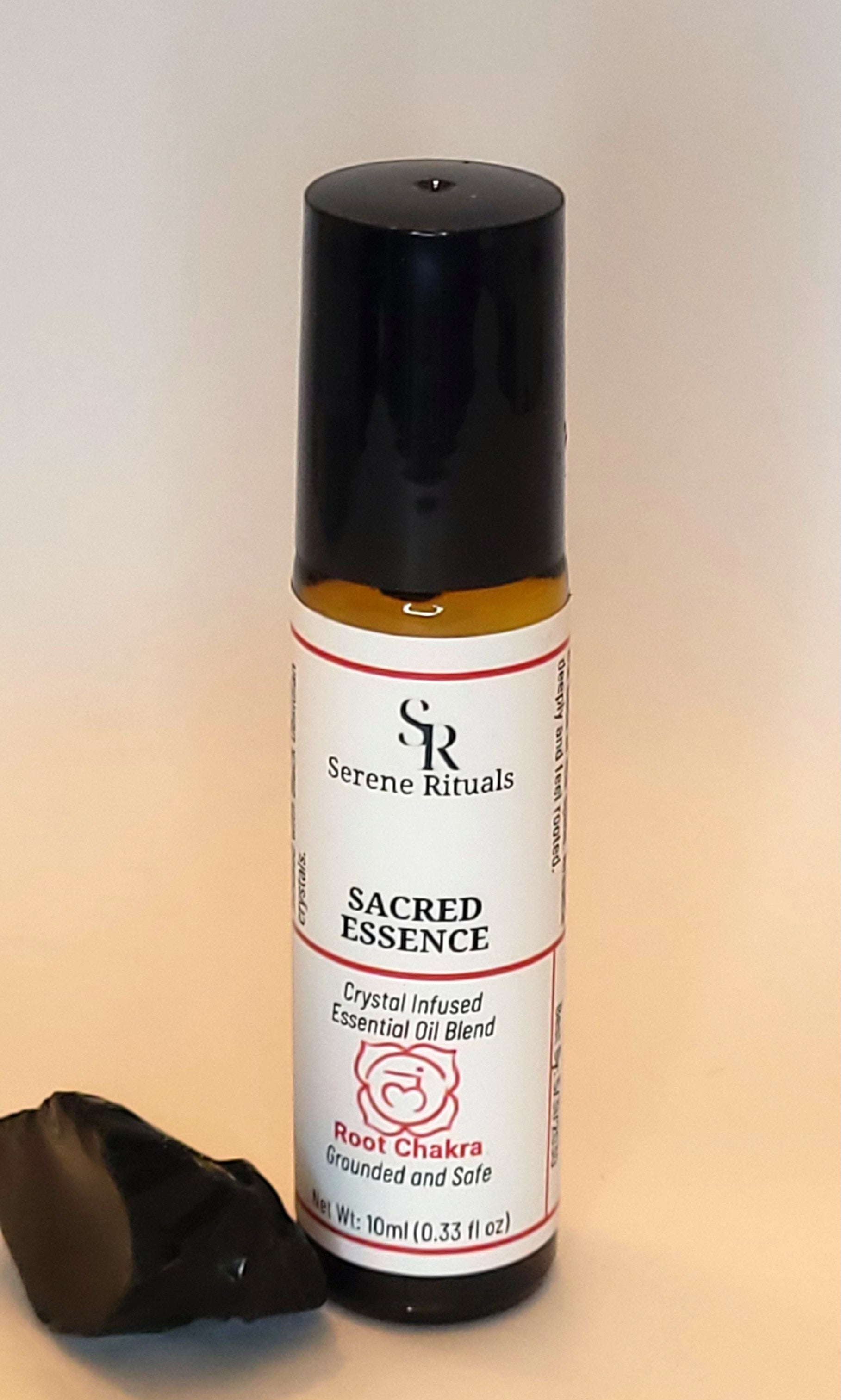 Sacred Essence essential oil bottle with a label on a light background
