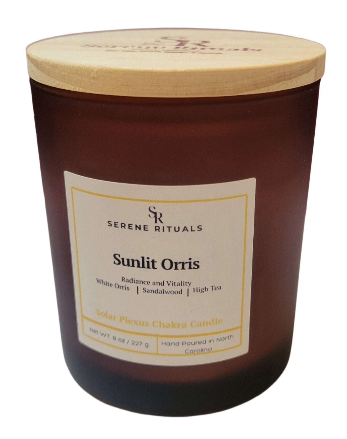 Scented candle labeled 'Sunlit Orris' by Serene Rituals on a white surface with a purple background.