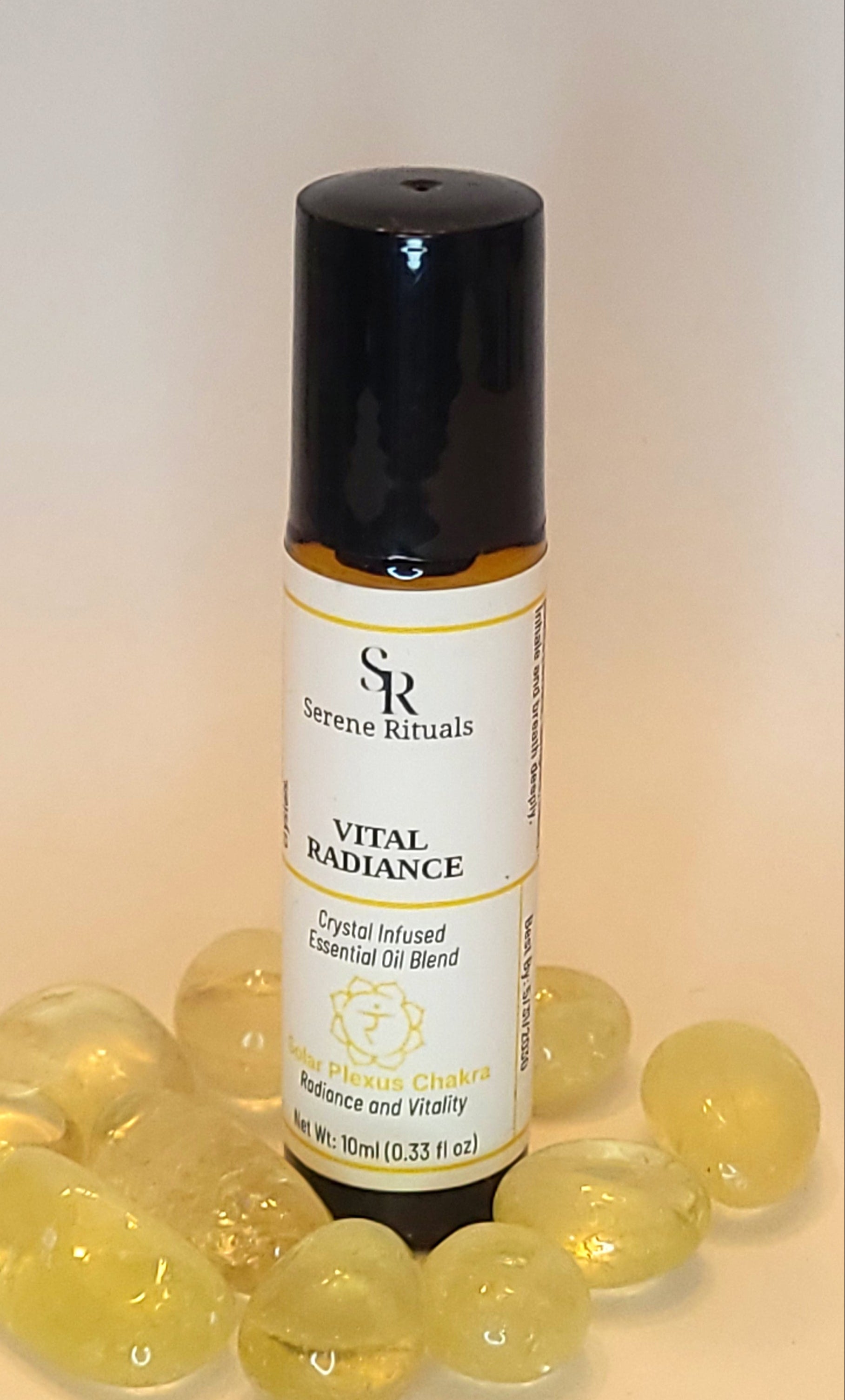 Serene Rituals Vital Radiance essential oil blend with a label and surrounding by Citrine crystals background